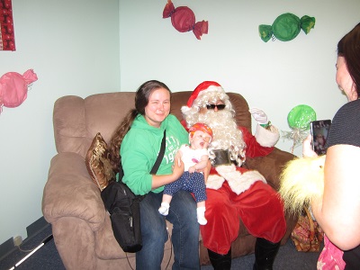 A Mother and her baby posing with Santa